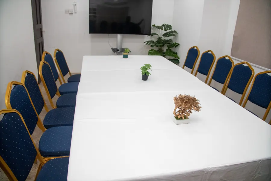 Conference table arrangement facing the presentation screen at yecSpace